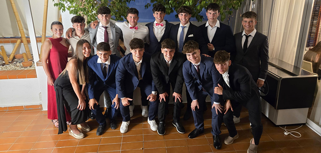 A group of students posing for a picture during graduation for ALCA